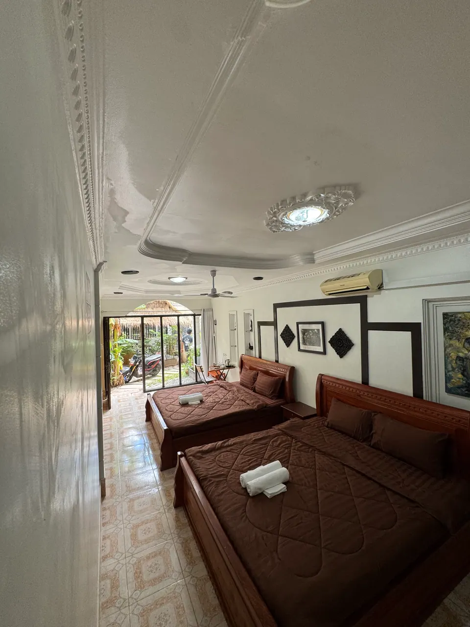Family room with two double beds and garden doors