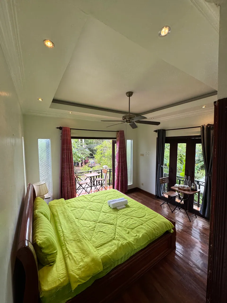 Superior king room with doors open onto a garden balcony
