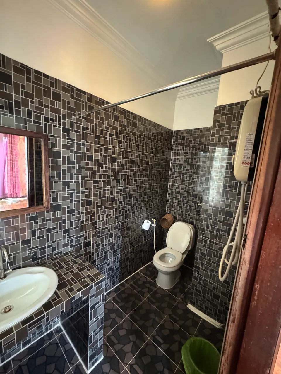 Mosaic-tiled bathroom with hot shower