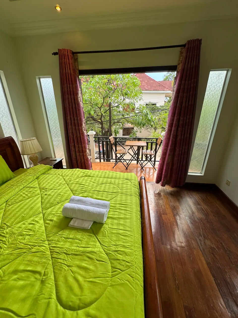 King bed looking out to the balcony and trees